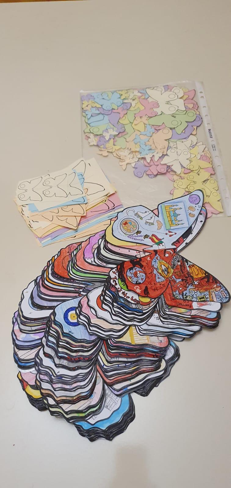 Stacks of cut-out decorated butterflies on a table