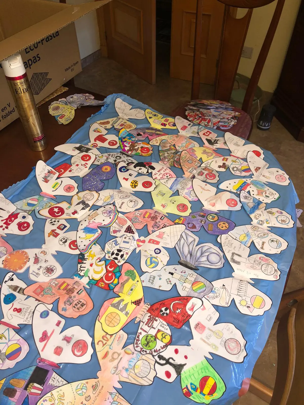 Dozens of decorated butterflies laid out on a table